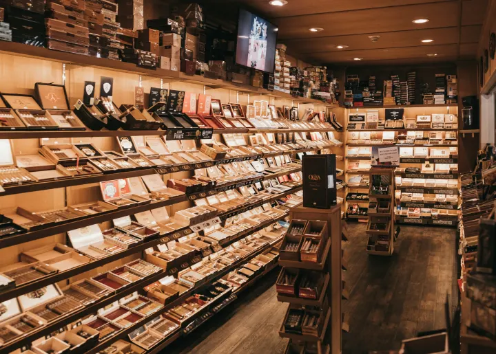 A cigar shop with floor-to-ceiling shelves of cigar boxes.