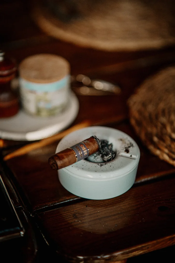 A cigar in an ashtray beside coffee, from Anatolie's photo collection